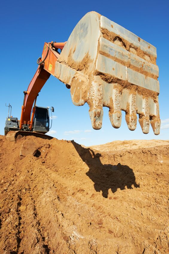 Excavator bucket digging dirt