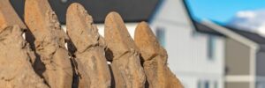 A close up shot of dirty and rusty metal excavator bucket teeth.